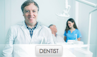 Middle-aged Smiling Dentist with Dental Assistant and Patient in Background