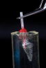 Fig 9. A clear polyvinyl siloxane (PVS) material was injected into a plastic tubular container, and the post assembly was submerged into the material. The container was placed into a pressure pot with cold water for 5 minutes, as shown in Fig 10. This procedure reduces the potential for the formation of voids and bubbles in the impression material. A slit was made in the top of the PVS material with a scalpel blade (#15 disposable scalpel), and the post assembly was carefully removed.