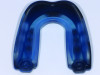 (1.) Example of a boil-and-bite sports mouth guard prior to fitting.