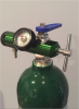 Fig. 2 The E tank of oxygen with an attached regulator.